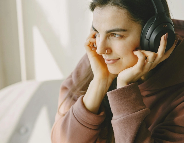 chica escuchando música en cascos, fuente de contaminación acústica